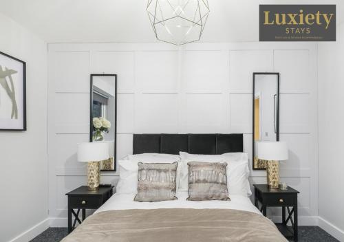 a bedroom with a large bed with two night stands at City Centre - Modern Apartment - by Luxiety Stays Serviced Accommodation Southend on Sea - in Southend-on-Sea