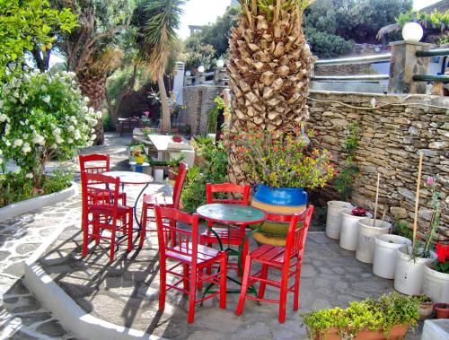 a group of red chairs and a table in a patio at Villa Rena in Batsi