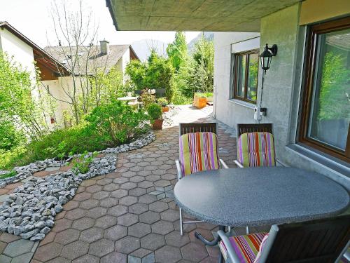 a table and chairs sitting on a patio at Apartment Mansalo by Interhome in Emmetten