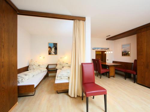 a hotel room with a bed and a table and chairs at Apartment Ringstrasse - Utoring-14 by Interhome in Leukerbad