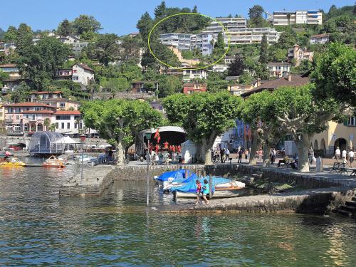 a group of boats sitting on the shore of a river at Apartment Double Room Classic-8 by Interhome in Ascona