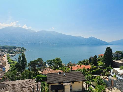 a view of a large body of water with mountains at Apartment Junior Suite Classic-19 by Interhome in Ascona