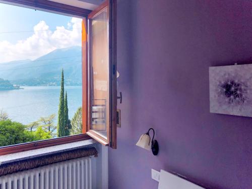 a window in a room with a view of the water at Apartment Stefania - VNA370 by Interhome in Varenna