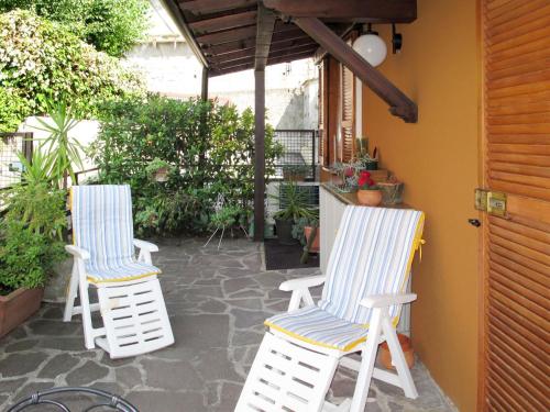 two chairs sitting on a patio next to a door at Apartment Stefania - VNA370 by Interhome in Varenna