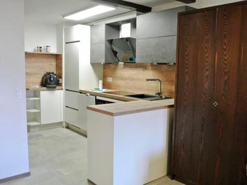 a kitchen with a sink and a counter top at Apartment Residenza Chesa Margun 14-7 by Interhome in Surlej