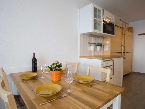 a dining room table with chairs and a bottle of wine at Studio Greppon 107 by Interhome in Les Collons