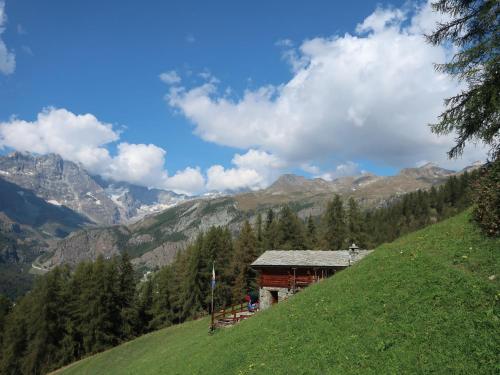a building on the side of a hill with mountains at Studio Ancienne Bergerie Studio 3 by Interhome in Valtournenche