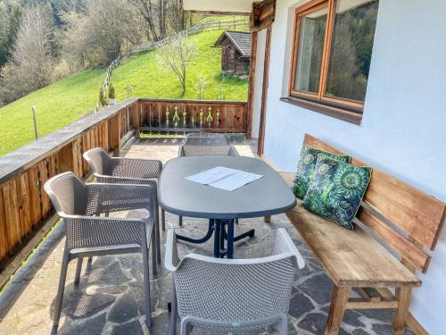 a patio with a table and chairs on a balcony at Apartment Häuser by Interhome in Ried im Zillertal