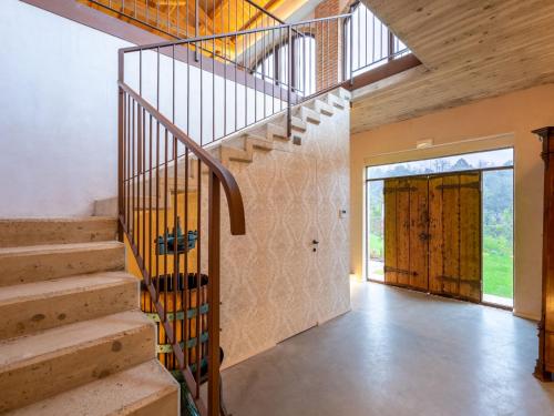 a staircase in a house with a wooden door at Holiday Home Tenuta Margherita by Interhome in Portacomaro