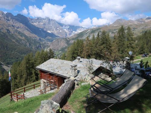 a couple of chairs sitting in front of a cabin at Studio Ancienne Bergerie Studio 2 - VOU141 by Interhome in Valtournenche