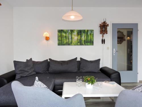 a living room with a couch and a table at Holiday Home Drachenfels by Interhome in Dittishausen