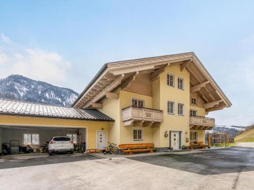 a building with a car parked in a parking lot at Apartment Achtalgut-1 by Interhome in Lend
