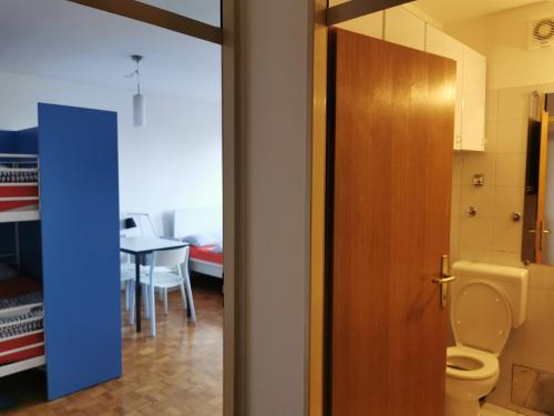 a bathroom with a toilet and a table at Dunajska Apartment in Ljubljana