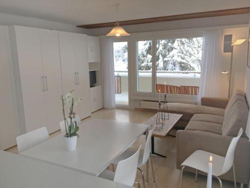 a living room with a couch and a table at Apartment Val Signina-2 by Interhome in Laax-Murschetg