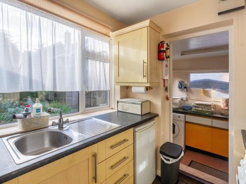 a kitchen with a sink and a window at Holiday Home Trappers End by Interhome in Whitstable