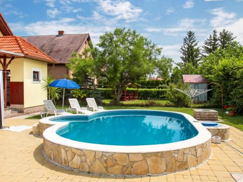 a swimming pool with a stone wall around it at Holiday Home Yellow 1 by Interhome in Balatonmáriafürdő