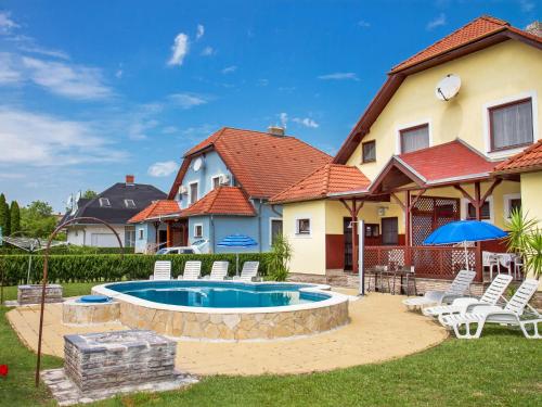 a house with a swimming pool in the yard at Holiday Home Yellow 1 by Interhome in Balatonmáriafürdő