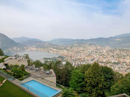 a view of a city from a house with a swimming pool at Apartment Aldesago Monte Brè - Utoring-22 by Interhome in Viganello