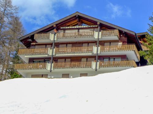 a building with snow in front of it at Apartment Sonnhalde B by Interhome in Zermatt