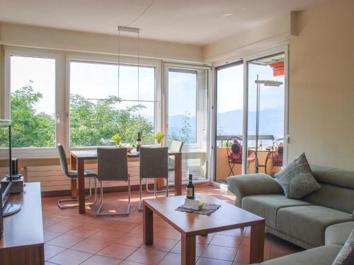 a living room with a couch and a table at Apartment Residenza Monte Bré - Apt-004 Haus1 by Interhome in Lugano