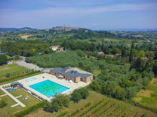 an aerial view of a house with a swimming pool at Camping Il Boschetto Di Piemma in San Gimignano