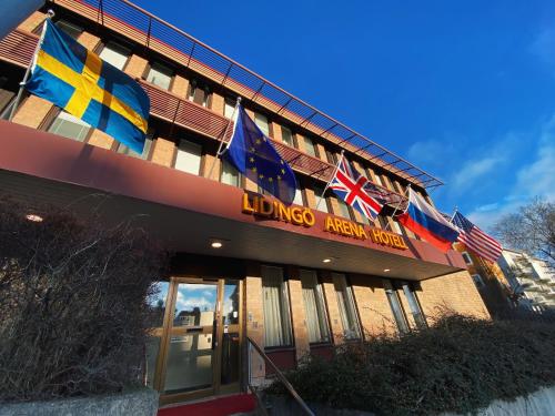 a hotel with flags flying outside of it at Lidingö Arena Hotel in Lidingö