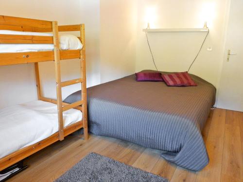 a bedroom with two bunk beds and a ladder at Apartment Les Bruyères 25 by Interhome in Chesières