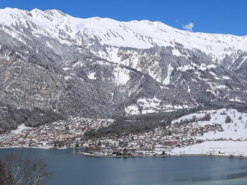 a town on a lake in front of a mountain at Holiday Home Chalet Aaregg by Interhome in Brienz