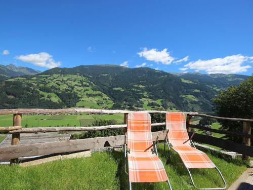 two orange barricades sitting on top of a fence at Apartment Hanna by Interhome in Kaltenbach