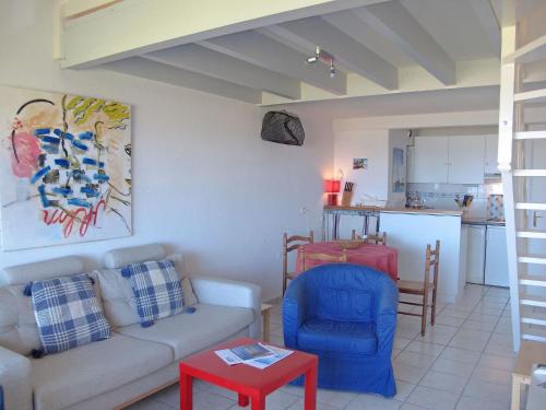 a living room with a couch and a table at Apartment Cap Océan by Interhome in Mimizan-Plage