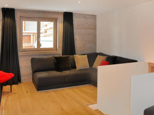 a living room with a couch and a window at Apartment Le Refuge 1 by Interhome in Nendaz