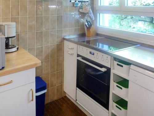 a kitchen with a stove and a counter top at Holiday Home Noisette by Interhome in Chardonne