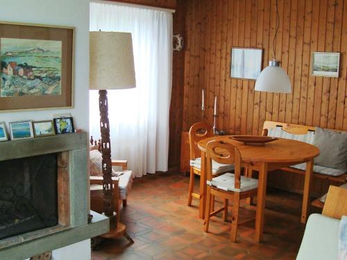 a living room with a table and a dining room at Holiday Home Noisette by Interhome in Chardonne