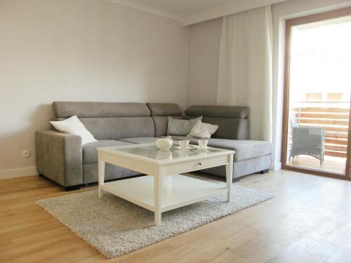 a living room with a couch and a coffee table at Apartment Na Wczasowej by Interhome in Ustka