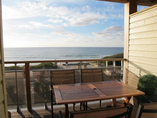 a balcony with a table and a view of the ocean at Studio Horizon-1 by Interhome in Mimizan-Plage