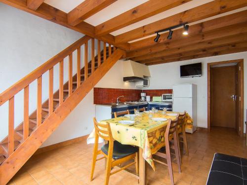 a dining room with a table and a kitchen at Holiday Home Sicard-6 by Interhome in Mimizan-Plage