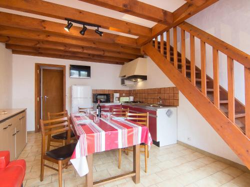 a kitchen with a table with a red and white table cloth at Holiday Home Sicard-10 by Interhome in Mimizan-Plage