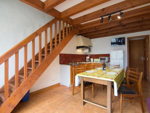 a kitchen with a wooden table and a staircase at Holiday Home Sicard-9 by Interhome in Mimizan-Plage