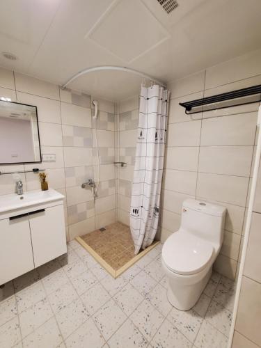 a bathroom with a toilet and a shower and a sink at 小窩旅店-羅東夜巿店 in Luodong