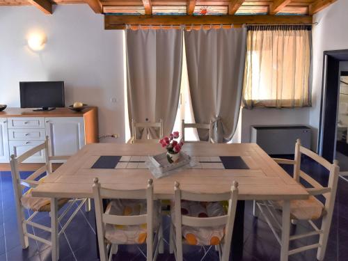 una mesa de madera y sillas en una habitación en Apartment Villa Isotta-3 by Interhome, en Rosolina Mare