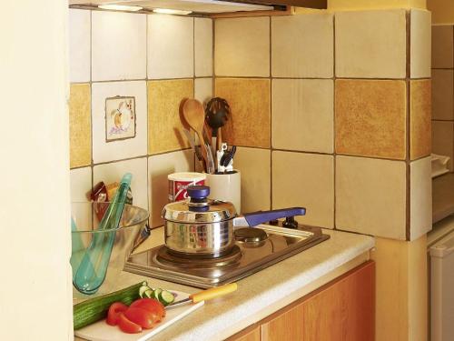 a kitchen counter with a pot on a stove at Apartment Villas Cavo Marathia 4 Apartments by Interhome in Marathias