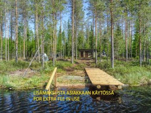 una pintura de un muelle de madera en medio de un bosque en Holiday Home Ellilä by Interhome en Palonurmi