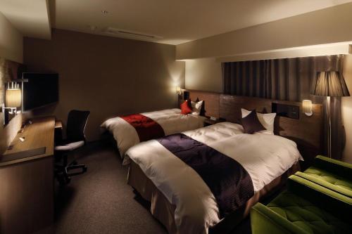 Gulta vai gultas numurā naktsmītnē Hotel Gate In Kagoshima Tenmonkan