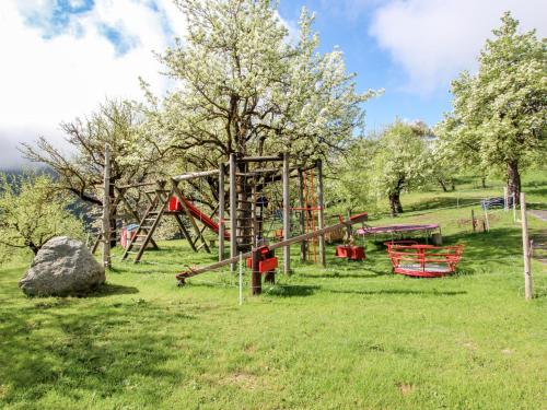 a playground in a field with trees and a rock at Apartment Untererhof-3 by Interhome in Pankrazberg