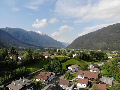 a village in a valley with mountains in the background at Apartment Ferien 2 by Interhome in Nassereith