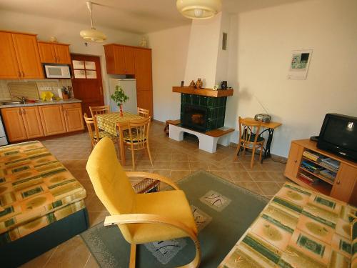 a kitchen and living room with a table and a stove at Holiday Home Parkany 1 by Interhome in Bechyně