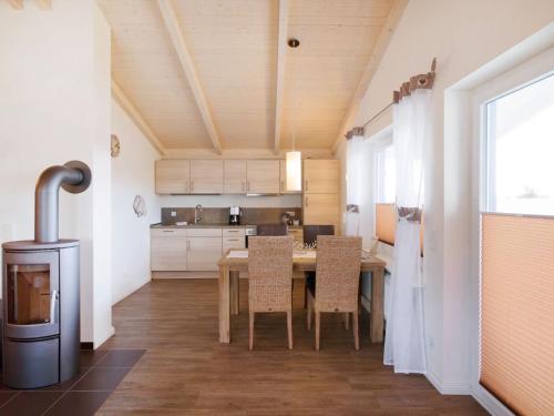a kitchen with a table and chairs in a room at Holiday Home Langeneß by Interhome in Dagebüll