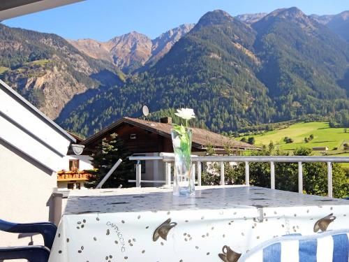 a vase on a table with a view of mountains at Apartment Frischmann-3 by Interhome in Umhausen
