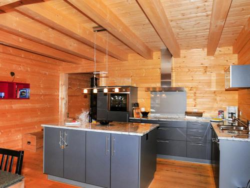 a large kitchen with wooden walls and wooden floors at Apartment Alpina by Interhome in Wengen