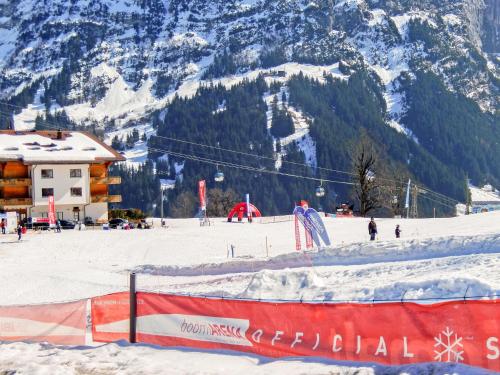 a ski slope with a ski lodge and a mountain at Apartment Chalet Bienli Mitte by Interhome in Grindelwald